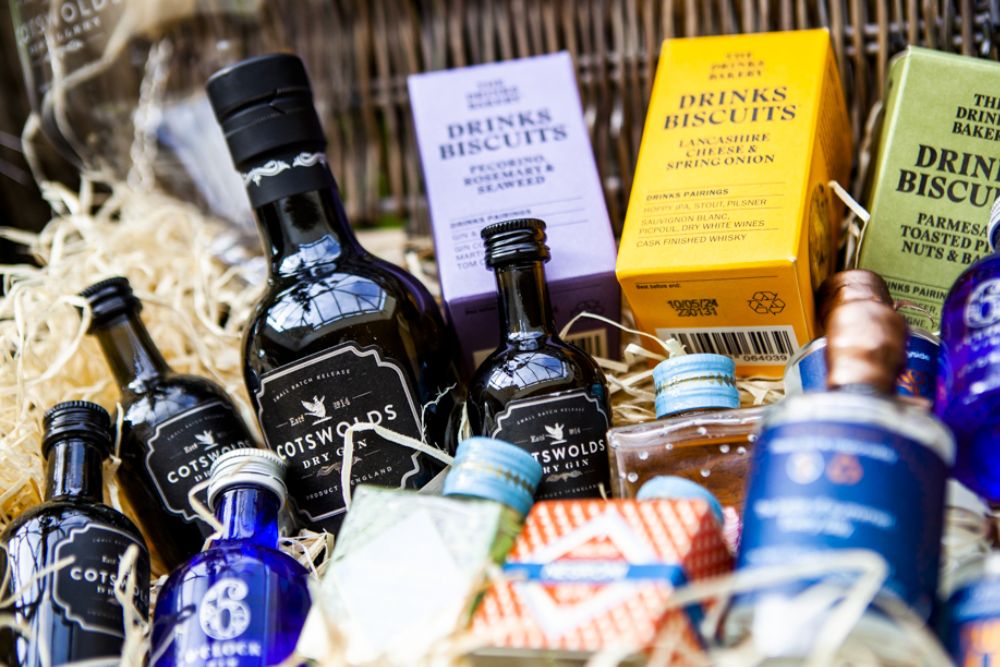 A gift hamper containing gins and biscuits